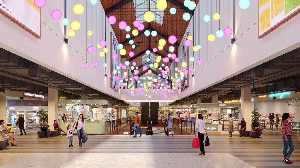 Retail mall interior featuring a range of shops and gradient illumination.