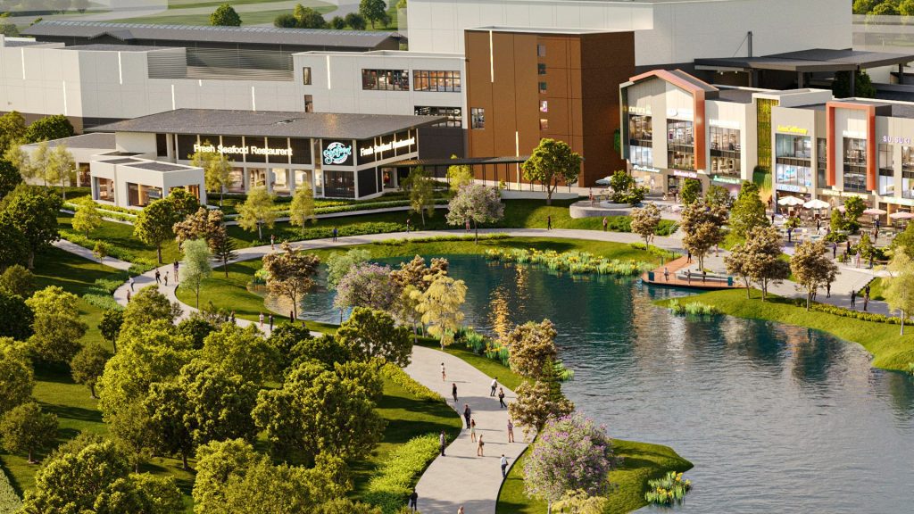 Lifestyle mall by a lakeside park providing retail, dining, and recreational spaces for the community.